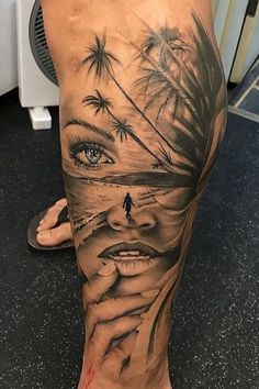 a woman's leg with tattoos and palm trees on it