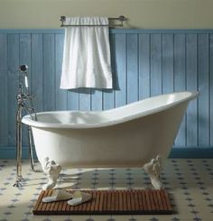 an old fashioned bathtub in a blue bathroom