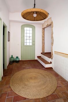 an entry way with a round rug on the floor