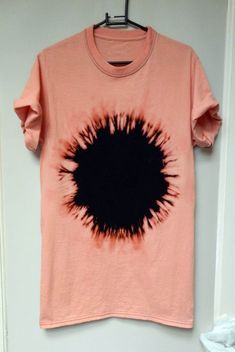 a t - shirt with an image of a black hole in the middle of it