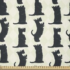 the silhouettes of cats and dogs are shown on this white, black - colored fabric