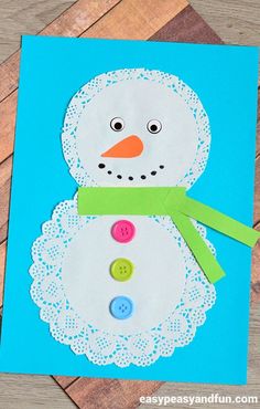 a snowman made out of paper with buttons on it