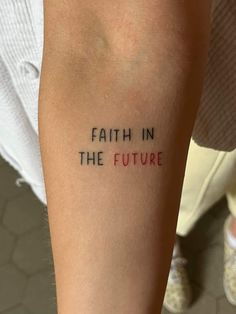 a person with a tattoo that says faith in the future