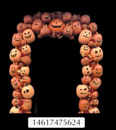 an arch made out of pumpkins with faces on them