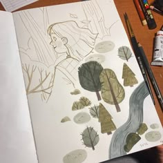 someone is drawing trees on paper with colored pencils