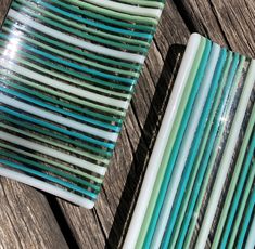 several different colored glass pieces sitting on top of a wooden table