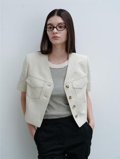 This is a.t.corner’s cropped V-neck jacket is made of cool linen blend fabric. The design's quality is enhanced with features like outer pockets, contrast stitching, and wooden-tone buttons. While it has a basic 4-button style, it gives the appearance of a 2-button jacket when buttoned up. This item can be styled as a set with a skirt or paired with various bottoms such as wide-leg pants. It's suitable for styling throughout the summer, offering a lightweight and natural look. The jacket has contrast fabric lining only in the body panel and no lining in the sleeves.- Perfect for daily wear- Can be styled with different looks to create various outfits- Its clean design makes it easy to match with any outfit, adding a stylish touch Beige Cropped Jacket With Button Closure, Linen Crops, Button Style, Button Jacket, Jacket Buttons, Natural Look, Crop Jacket, Clean Design, Light Beige