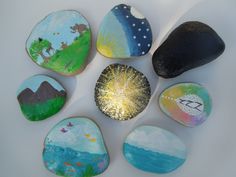 six painted rocks with different designs on them