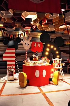 a mickey mouse themed birthday party with lights and decorations