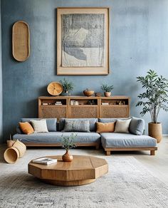 a living room with blue walls and furniture in the corner, including a couch, coffee table