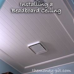 a man is installing a ceiling fan in a room with blue walls and white trim