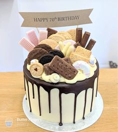 a birthday cake decorated with cookies, marshmallows and chocolate