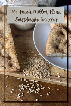 a wooden cutting board topped with two pieces of bread next to a bowl of oatmeal