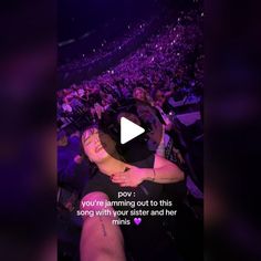 a woman is hugging her friend in the audience at a concert with an ad on it