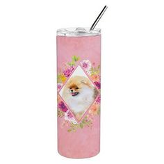 a pink tumbler with a pomeranian dog on the side and flowers around it's sides