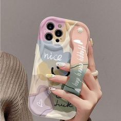 a woman is holding up her phone case