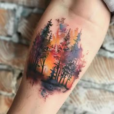 a colorful forest tattoo on the arm