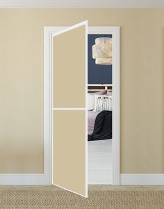 an open door leading to a bedroom with a bed in the background and beige walls