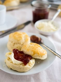 scones with jam and butter on a white plate