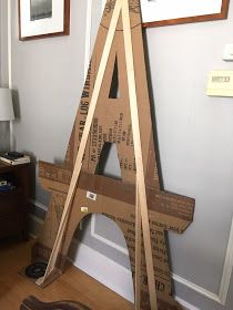 an unfinished wooden sign sitting on top of a hard wood floor next to a wall