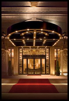 the entrance to a hotel with red carpet and lights