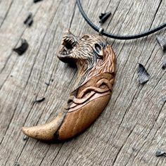 a wooden necklace with a carved animal on it