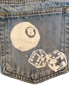 the back pocket of a pair of jeans with patches on it and a smiley face