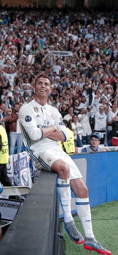 a man sitting on top of a bench in front of a crowd