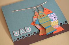 a father's day card with two fish hanging from the strings and words dad on it