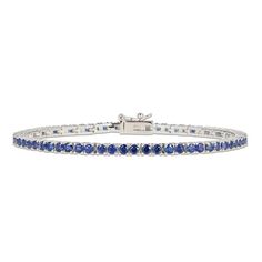 This elegant line bracelet is adorned with sumptuous round blue lab-created sapphires that shimmer within links of sterling silver. The bracelet measures 7.25 inches and secures with a box clasp. Classic Round Sapphire Diamond Bracelet, Formal Sapphire Round Bracelets, Formal Round Sapphire Bracelet, Classic Sapphire Gemstone Tennis Bracelet, Classic Sapphire Tennis Bracelet With Round Shape, Classic Blue Diamond Bracelet In Sterling Silver, Classic Sapphire Tennis Bracelet With Prong Setting, Elegant Blue Diamond Bracelet With Prong Setting, Blue Tennis Bracelet With Prong Setting For Formal Occasions