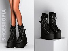 a pair of black boots with spikes and chains on them are shown in front of a white background