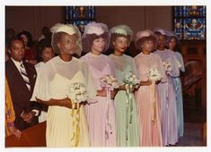 a group of women standing next to each other in front of a church pews