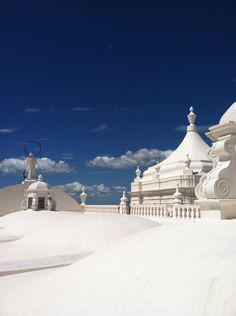 some white buildings are covered in snow under a blue sky