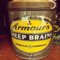 an old tin can sitting on top of a wooden table