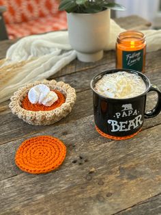 there is a cup of coffee on the table with two coasters next to it