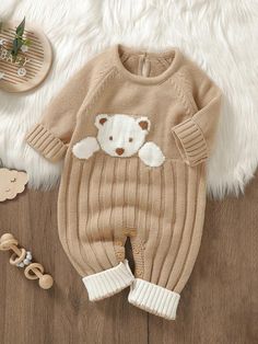 a teddy bear sweater and pants on a wooden floor