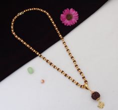 This handmade, gold plated Rudraksha mala is textured with a matt finish and brass beads. Adorned with a golden Aum pendant, this mala is blessed with the sacred power of the Rudraksha beads and the healing energy of the Aum symbol. Perfect for meditation and yoga practitioners. Mala Dimension Height:63 cm (24.8 inch) Width:6 mm (0.6 cm) Depth:6 mm (0.6 cm) Pendant Dimension Height:48 mm (5.3 cm) Width:20 mm (2.0 cm) Depth:20 mm (2.0 cm) Other Specification Weight:32 Gram Size:Fixed Lock Type:S Rudraksh Bracelet For Men In Gold, Gold Mala With 8mm Beads For Meditation, Gold 108 Beads Mala For Meditation, Gold Mala With 108 Beads For Meditation, Gold Mala With 108 Beads For Rituals, Aum Symbol, Jhumka Designs, Rudraksha Mala, Rudraksha Beads