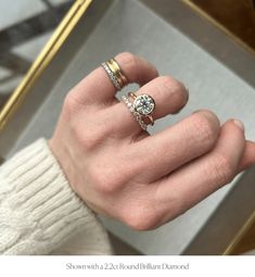 a person's hand with two rings on their fingers and one ring in the middle