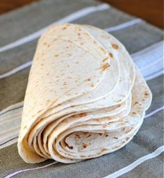 a tortilla sitting on top of a striped napkin