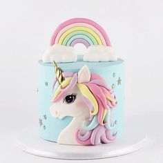 a cake decorated with a rainbow and clouds