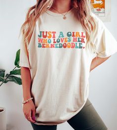 a woman wearing a t - shirt that says just a girl who loves her berenoodle