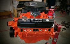 an orange and black engine in a garage