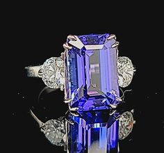 GORGEOUS 14k white gold engagement tanzanite rlin emerald shape Center natural tanzanite in emerald weight 6.32ct. size 13x8.6mm gorgeous violet blue color nice luster very lively ,brilliant spakly and clean. side two natural diamonds total weight 1.17ct. Size 5.3mm H -SI1 ring size 6 Resizable Appraisal available Retail value $9,500 net . Emerald-cut Tanzanite Jewelry With Vvs Clarity, Gia Certified Emerald Cut Tanzanite Jewelry, Gia Certified Tanzanite Emerald Cut Rings, Emerald Ring Vintage, Emerald Gem, Filigree Engagement Ring, White Gold Engagement, White Gold Engagement Rings, Filigree Ring