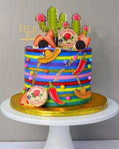 a colorful cake decorated with fruit and vegetables