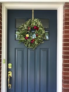 a blue front door with a wreath on it