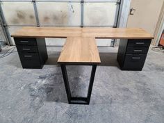 an office desk made out of black metal and wood with two drawers on each side