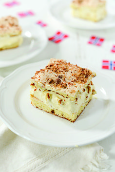 three desserts on white plates sitting on a table with red, white and blue napkins