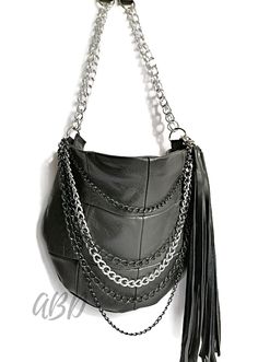 "Leather handbag Black leather purse Leather shouler bag Leather tassel bag Black tassel bag Black bag chains Leather chains bag Chain purse Soft leather purse Black shoulder purse Genuine leather bag Genuine leather Chain strap purse Chain strap bag This is a medium size bag.Its simple and functional character allows you to fit everything you need inside throughout your entire day. It is voluminous yet neat, making it a great addition to a loose fitting and elegant clothing. This leather bag is made for women who appreciate comfort, harmony and style. FEATURES: designed to be worn over the shoulder,In your hand inside pocket for mobile ( two opened ) finished with cotton lining MATERIALS: Italian soft leather cotton lining rivets zipper metal COLORS: Black DIMENSIONS: Height 9,45\" / 24 c Edgy Handbags, Black Shoulder Purse, Soft Leather Purse, Black Leather Handbag, Soft Leather Bag, Italian Leather Bags, Chain Purse, Black Leather Bag, Black Crossbody Purse