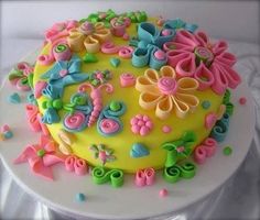 a cake decorated with flowers and butterflies on a plate