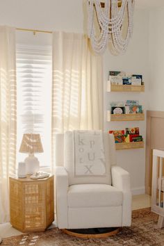 a baby's room with a rocking chair, crib and bookshelf